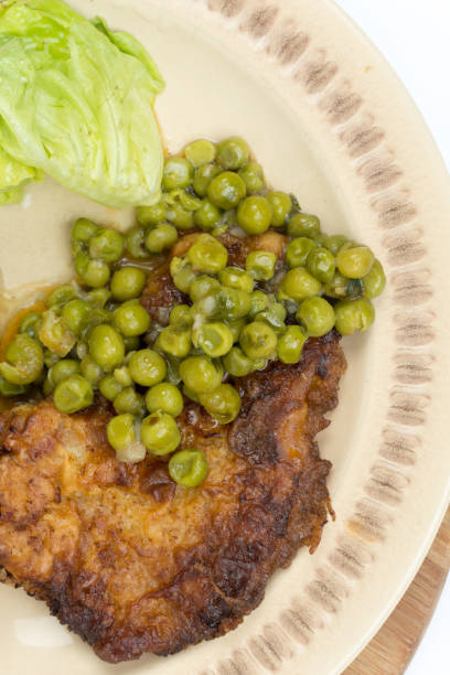 istock Flat lay fried steak green peas potatoes 1221419314