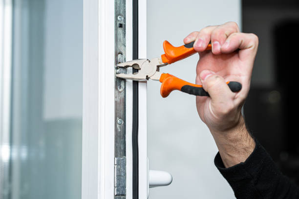 istock Professional master for repair and installation of windows, sets up a window opening system in winter mode 1221419406