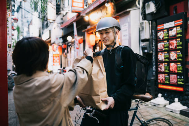 istock Bike Courier Receiving A Delivery 1221419484