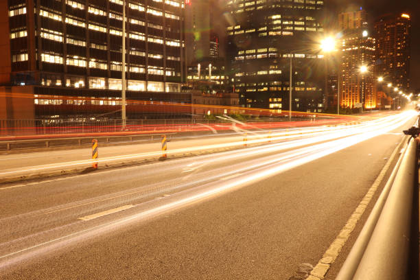 istock Car light trail shot at night in city centre 1221420636