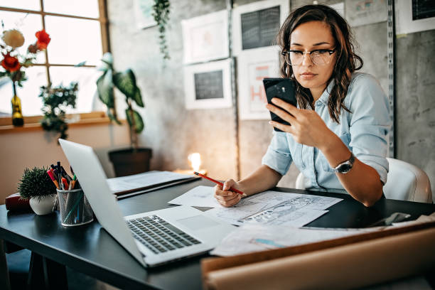 istock Multitasking of young female entrepreneur at home office 1221420659