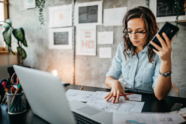istock Multitasking of young female entrepreneur at home office 1221420679