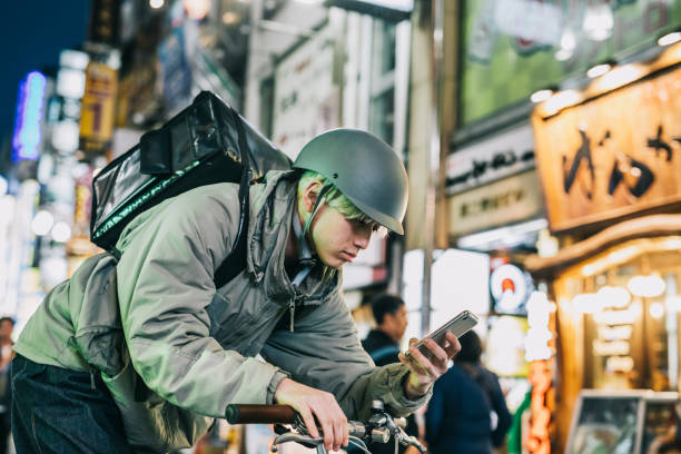 istock Food Courier Checking His Smartphone 1221420918