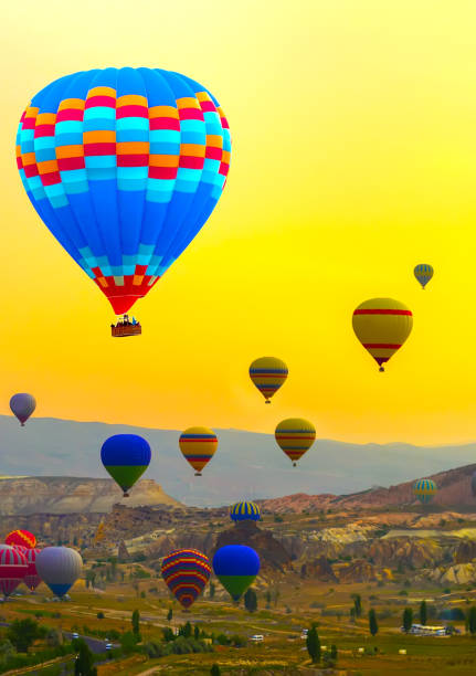 Sunset Hot air balloons landing mountain Cappadocia Goreme National Park Turkey tourist attraction
