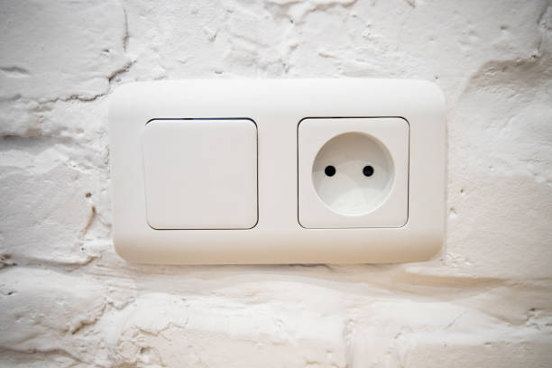 istock A group of white european electrical outlets and a switch located on a white wall 1221422961