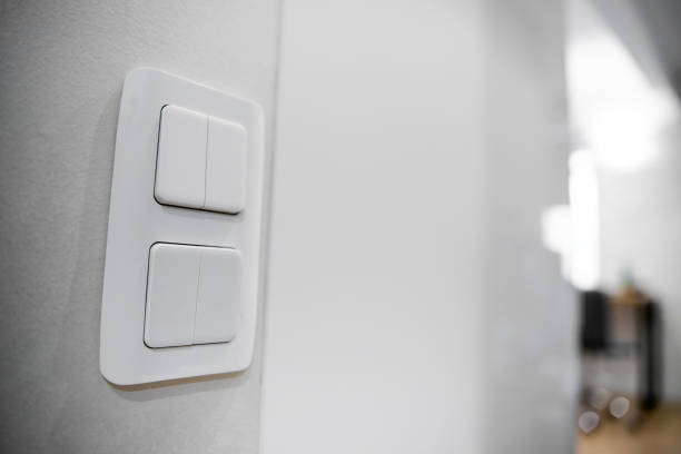 istock white lighting switches on concrete wall, on and off 1221423538