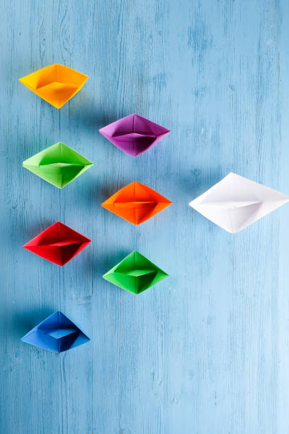 istock Colored paper boats on a blue background 1221424031