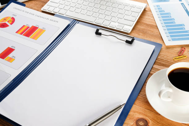 istock Computer, business chart and coffee on the table. Business items on the desktop. Workplace of a businessman. 1221424340