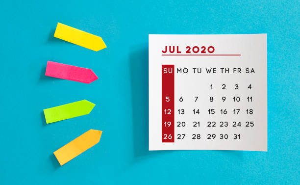 istock Calendar concept. July 2020 Calendar On The White note paper. Colored arrow-shaped sticky notes point to it. 1221425412