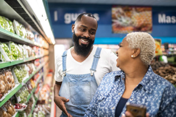 istock Couple buying at supermarket using mobile phone 1221425419