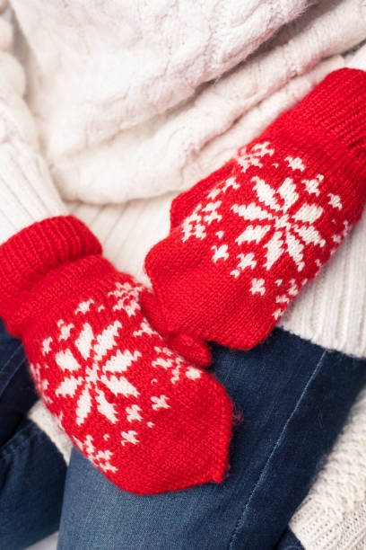 istock Hands in red mittens with snowflake ornament 1221426105