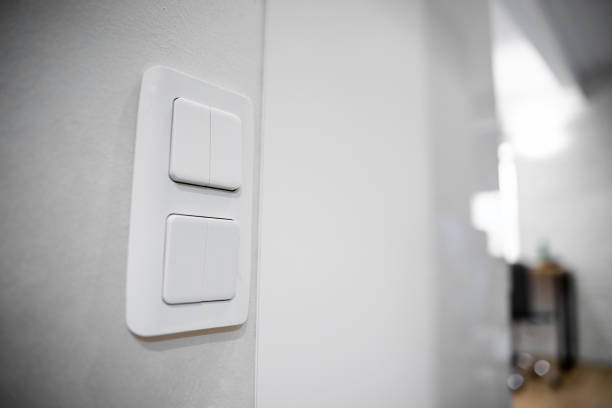 istock white lighting switches on concrete wall, on and off 1221426260