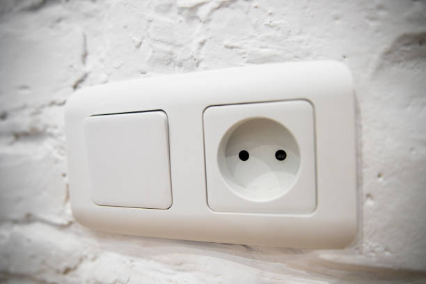 istock A group of white european electrical outlets and a switch located on a white wall 1221426345