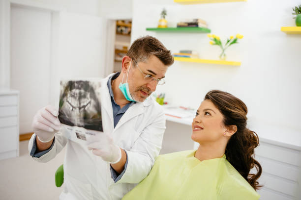 istock Dentist showing a patient her x-ray 1221426409