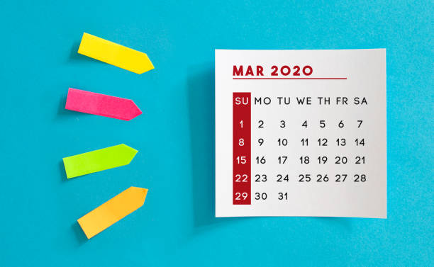 istock Calendar concept. March 2020 Calendar On The White note paper. Colored arrow-shaped sticky notes point to it. 1221426475