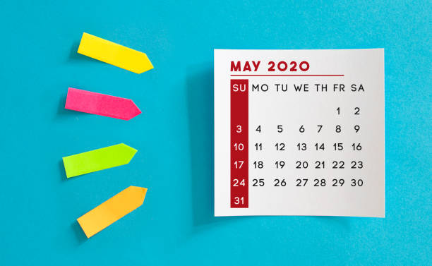 istock Calendar concept. May 2020 Calendar On The White note paper. Colored arrow-shaped sticky notes point to it. 1221427227