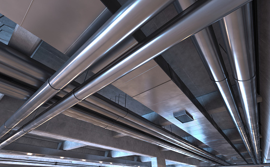 Pipes, tubes and air ducts on a garage ceiling or underground space. Metal, aluminum and steel equipment. Engineering details. Modern industrial background with dim illumination. Digitally generated image.