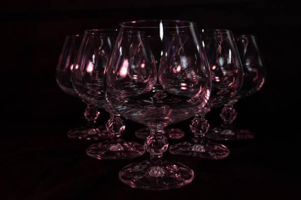 istock studio black background photo. clear crystal glasses on a dark background with beautiful lighting 1221429142