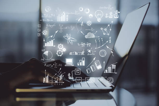 istock Hand using laptop with glowing business plan hologram 1221429329