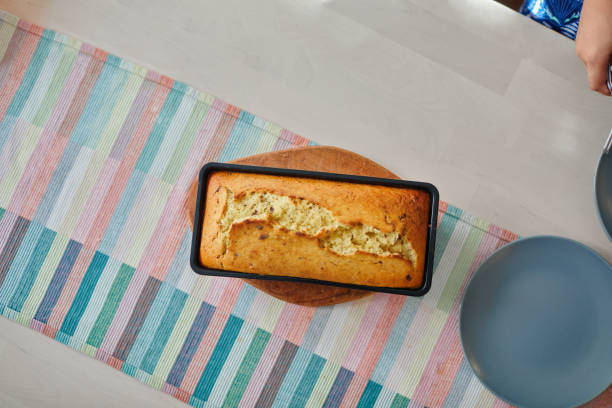 Banana bread fresh out of the oven cools down on the table.