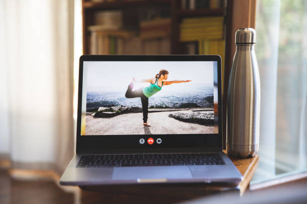 istock Young woman practicing Yoga in video call from home 1221430393