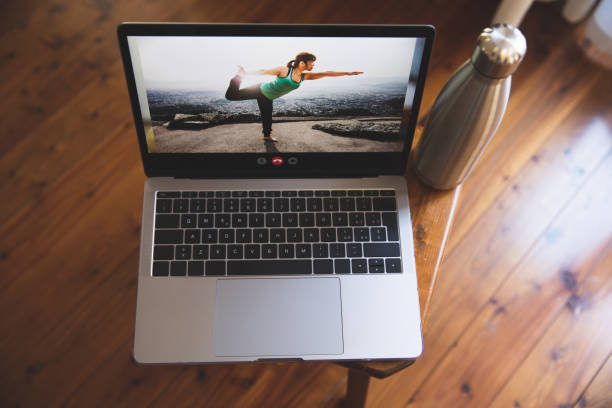 istock Laptop connected for the upcoming yoga online training class 1221430581