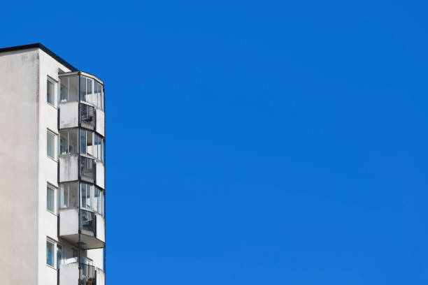 A weathered apartment building and blue sky.