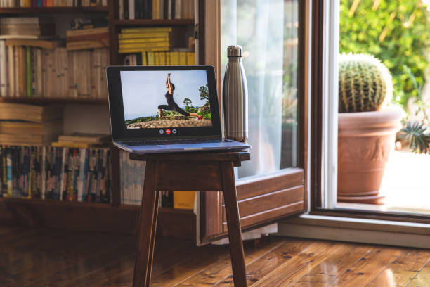 istock Laptop connected for the upcoming yoga online training class 1221431189