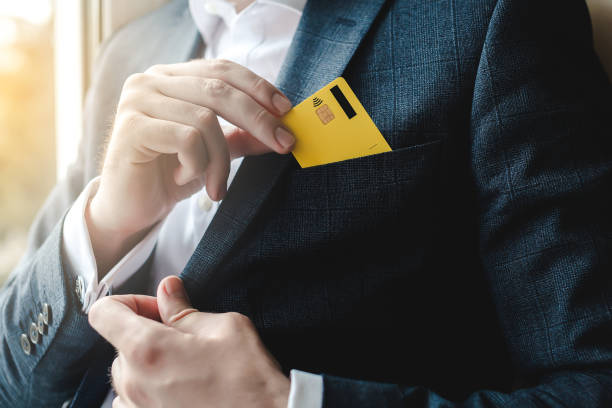 istock Man putting credit card in suit pocket 1221431961