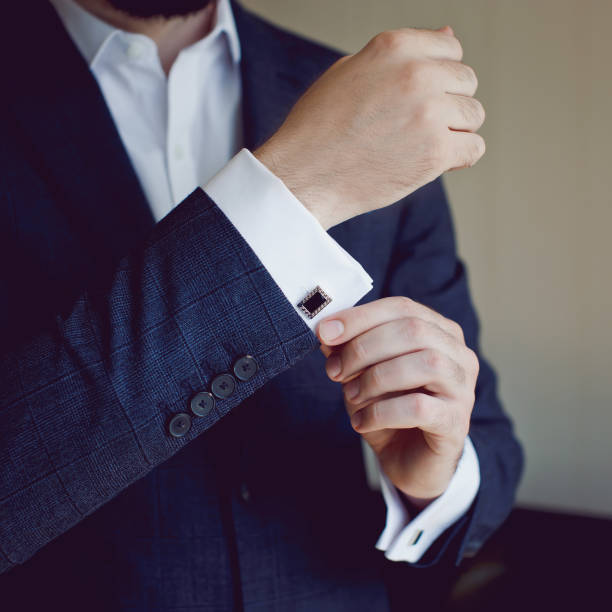 Hands of wedding groom getting ready in suit stock photo
