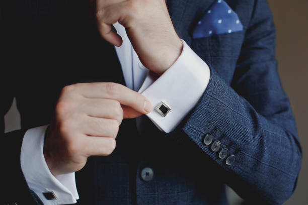 istock Hands of wedding groom getting ready in suit 1221432019