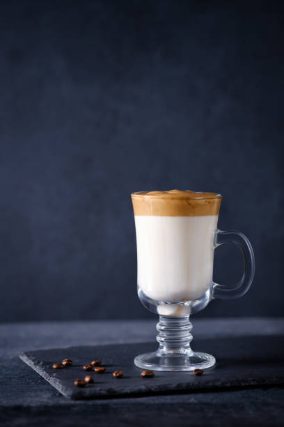 istock Whipped dalgona coffee on a dark background with copy space. Korean coffee drink. Vertical composition 1221432040