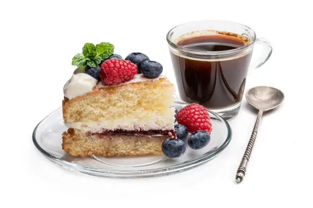 Photo of Victoria sponge cake with whipped cream and berries on top isolated on white