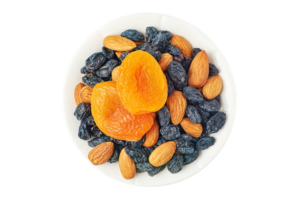 istock Bowl of dried fruits on white 1221435255