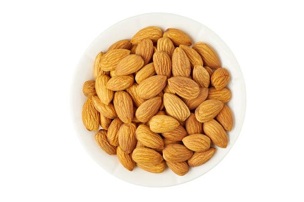 istock Bowl of raw almonds on white 1221435386