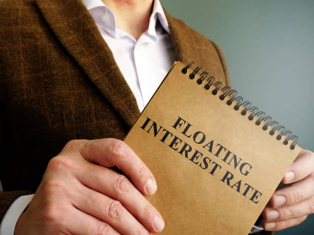 istock Man holds information about floating interest rate. 1221435477