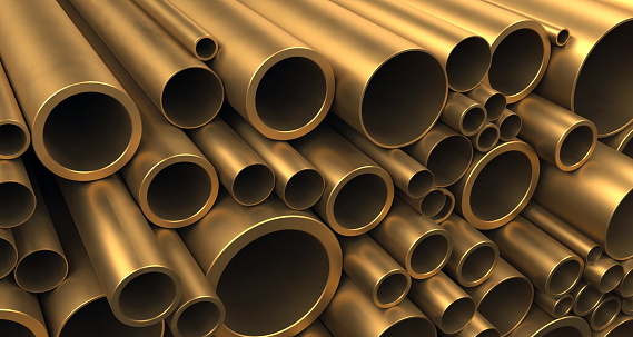 Large heap of bronze tubes and pipes of various sizes and diameters stacked on each other. Warehouse samples. Construction industry and metalware. Digitally generated image.