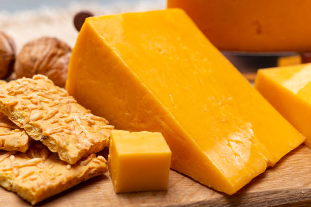istock Red waxed yellow cheddar cheese and crackers with grated cheese 1221435600