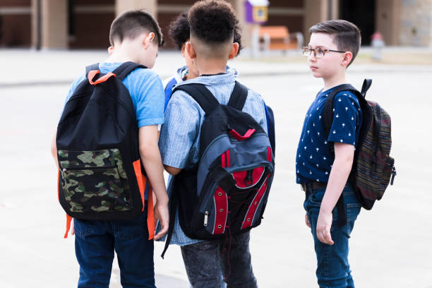 istock Group of school boys have serious conversation 1221435705