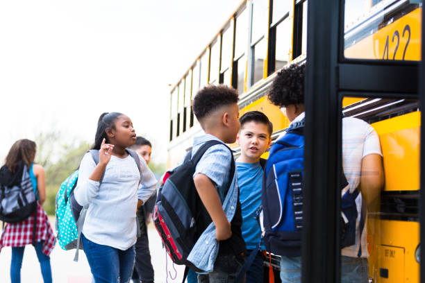 istock School buddies board school bus 1221435758