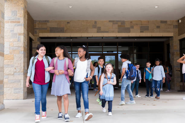istock Schoolgirls leave school building together 1221435769