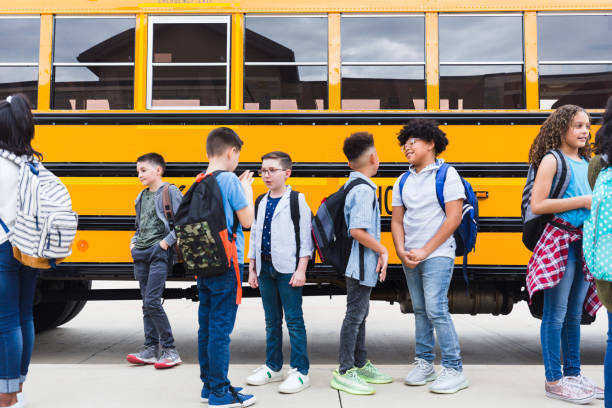 istock Diverse students in front of school bus 1221435784