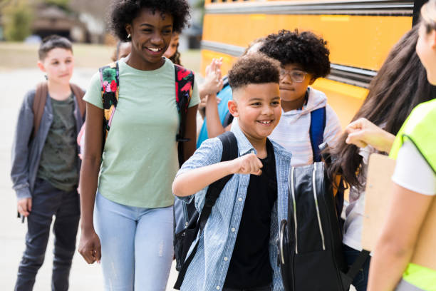 istock Schoolboy gives bus driver a fist bump 1221435813