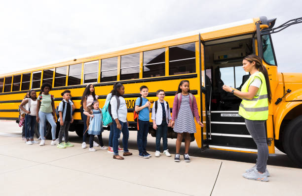 istock Bus driver takes attendance as student board school bus 1221435877