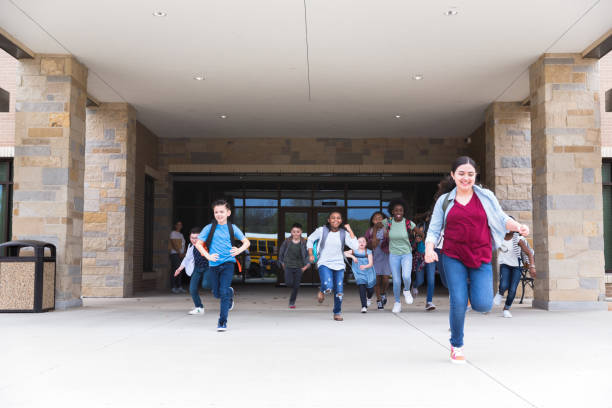 istock Students run from school at the end of school year 1221435879