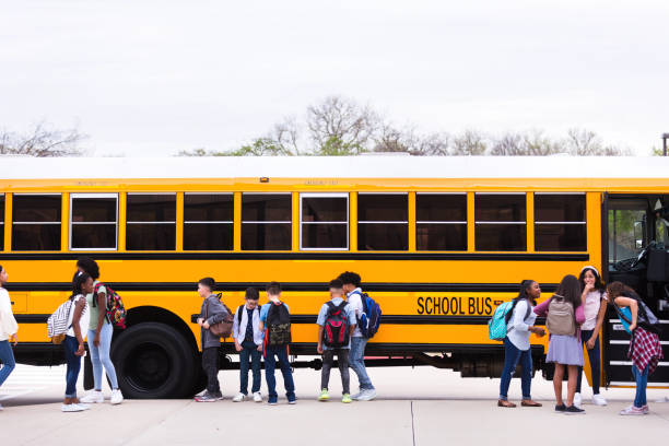 istock Diverse students in front of school bus 1221435884