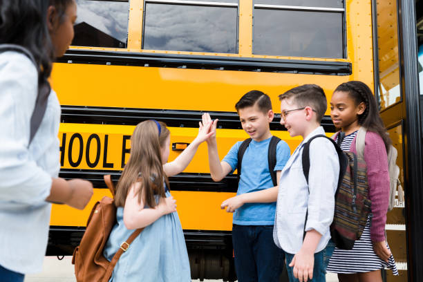 istock Elementary schoolboy gives friend a high five 1221435888