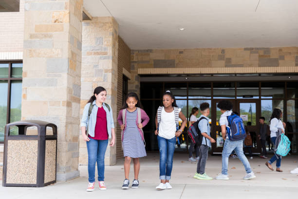 istock Middle school friend leaving school building 1221435891