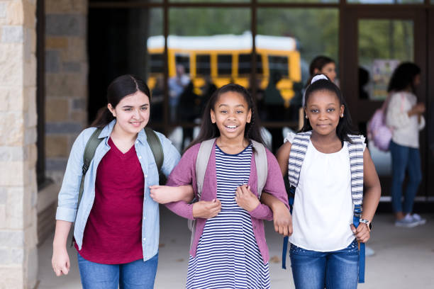 istock Schoolgirls leaving school together 1221435935