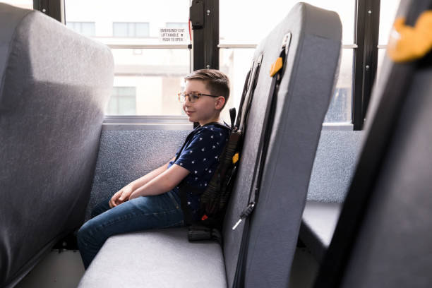 istock Young elementary age boy waits patiently on school bus 1221436003